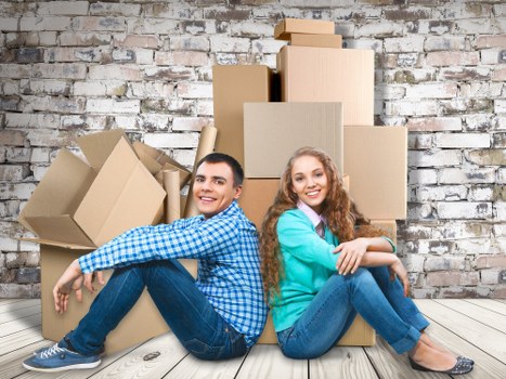 Removalists carrying boxes through a Shoreditch apartment building
